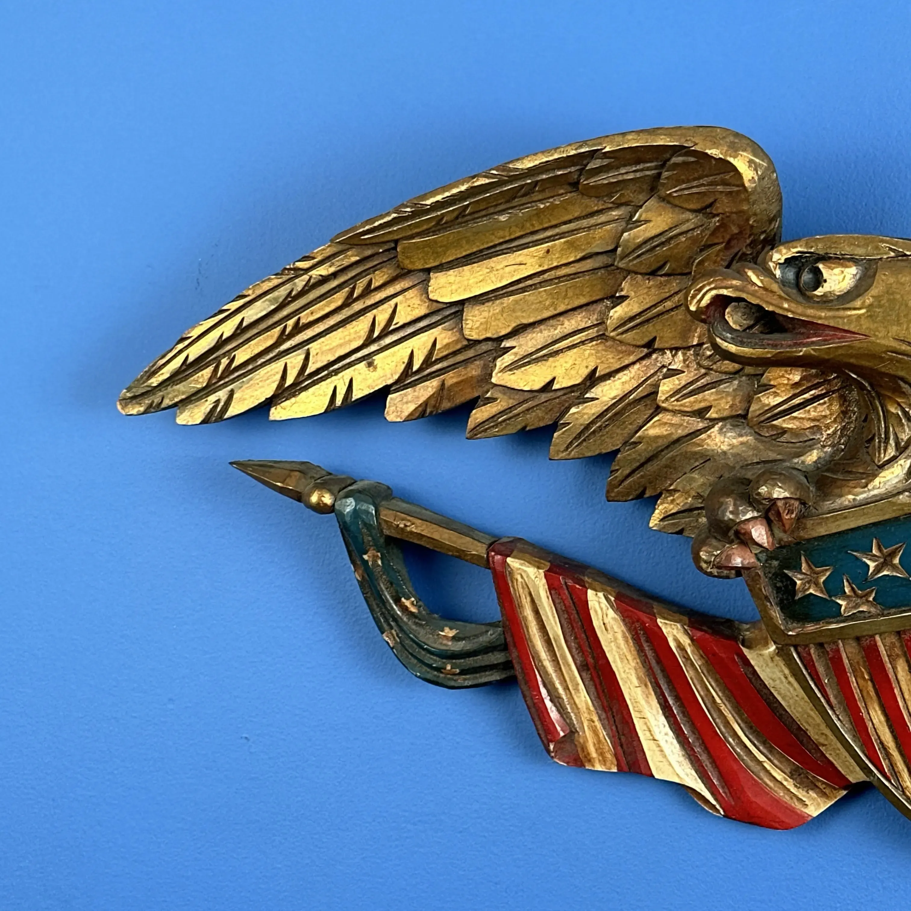 Carved wooden eagle with a shield and two flags — 29” wide