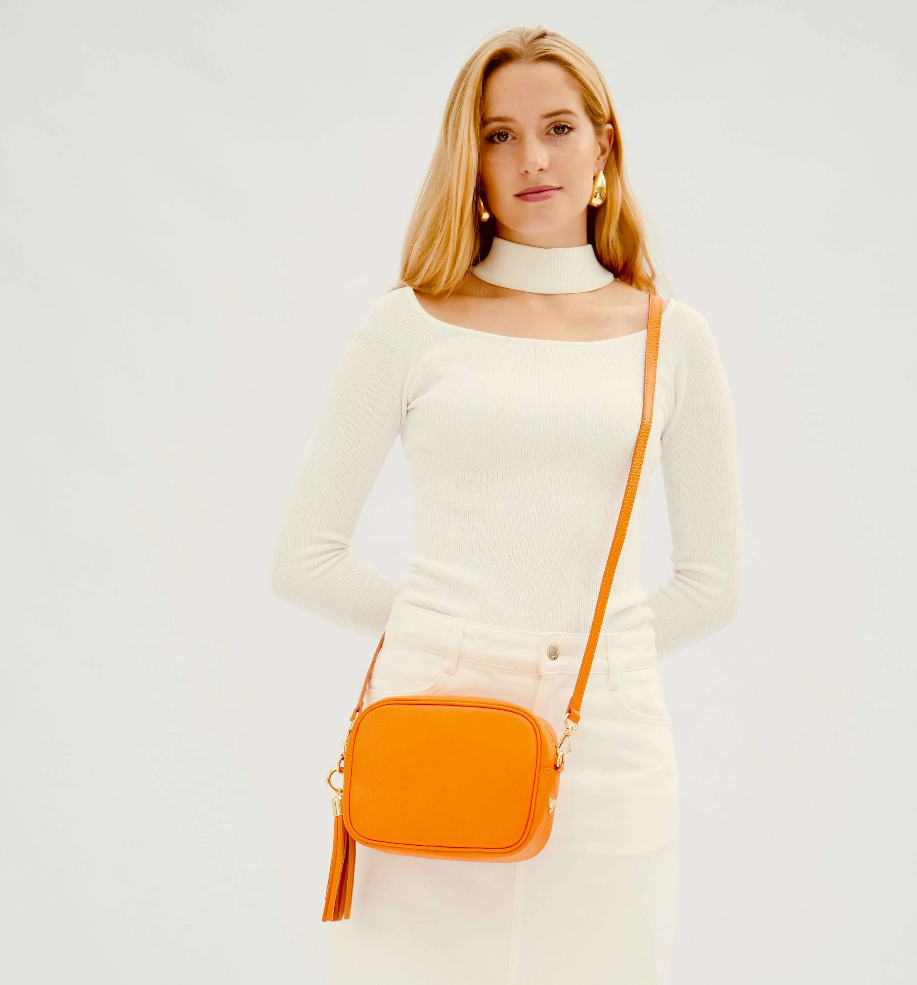 The Tassel Orange Leather Crossbody Bag With Orange & Gold Stripe Camo Strap